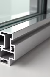 A close-up cross-section of a window frame, likely an aluminum extrusion, showing its internal structure and where glass would be inserted.